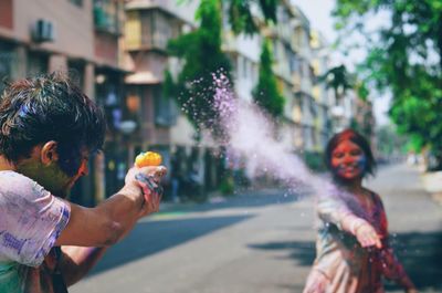 People playing on street during thai new year festival