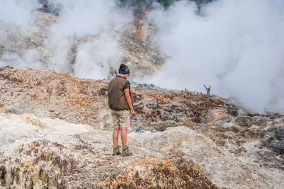 Full length of man standing on rock