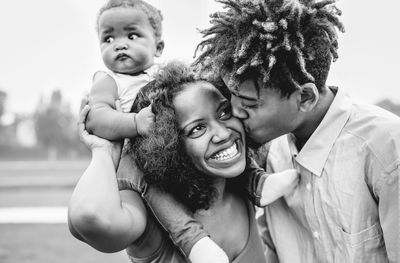 Happy parents with cute daughter in park