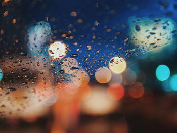 Close-up of water drops on illuminated rainy season