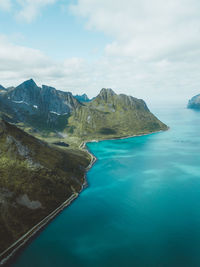 Scenic view of sea and mountains against sky