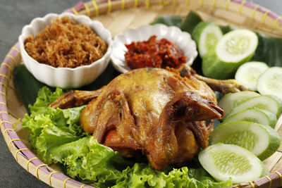 Ayam goreng lengkuas, fried whole chicken with shredded galangal serundeng and spicy sambal