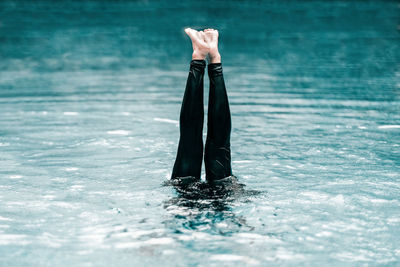 Cropped image of woman leg in swimming pool