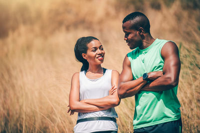 Couple with arms crossed looking at each other