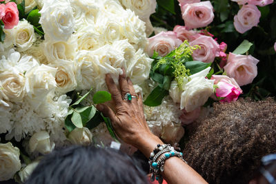 Midsection of woman with bouquet