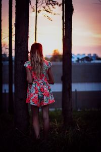 Woman standing at sunset