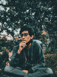 Portrait of young man sitting outdoors