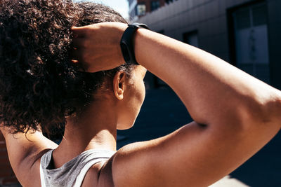 Close-up of woman with arms raised