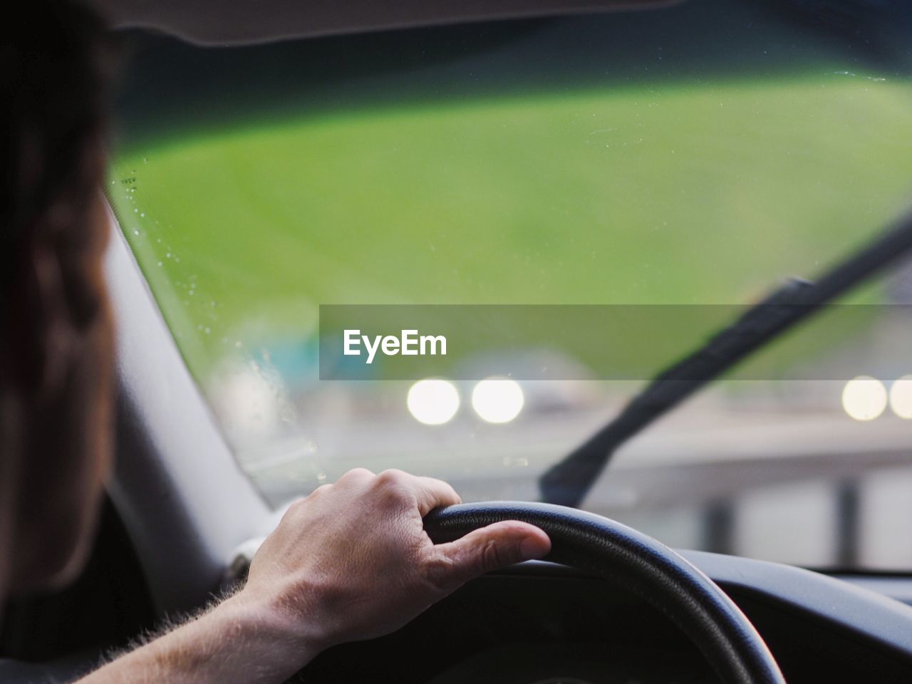 Cropped image of man driving car