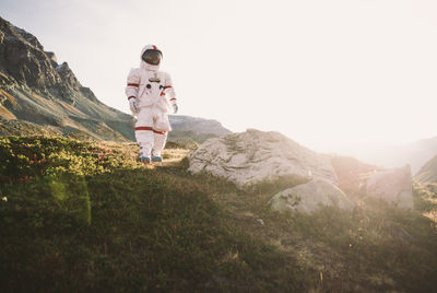 Full length of astronaut standing against sky