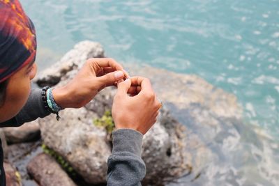 A man is seen putting on a fishing hook