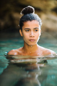 Thoughtful young woman swimming in sea