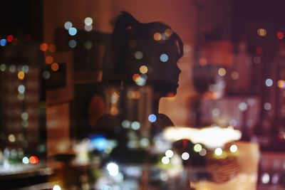 Defocused image of illuminated christmas tree at night