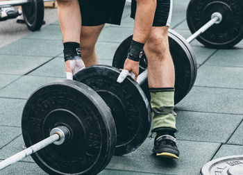 Low section of person in gym doing weightlifting