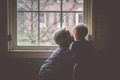 Boys looking through window