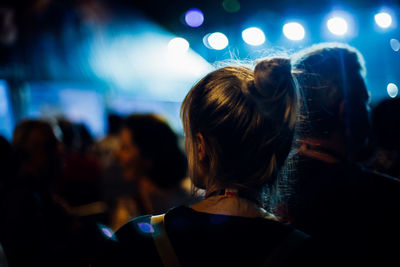 Rear view of people enjoying at music concert