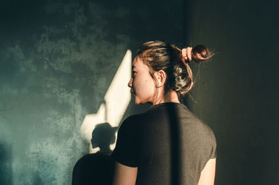 Woman standing against wall