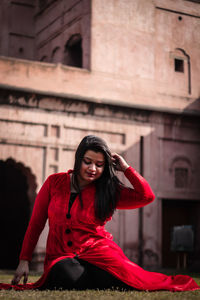 Portrait of smiling young woman sitting outdoors