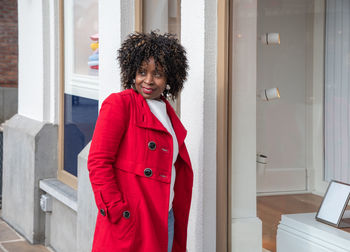 Curvy african american woman with shopping bags standing on the street