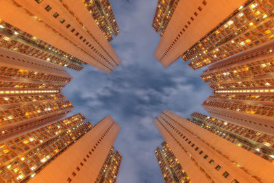 Low angle view of illuminated buildings against sky in city