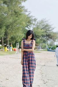 Full length of young woman standing on land