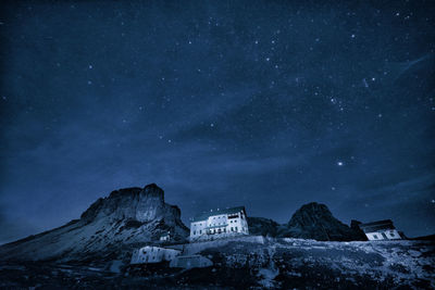 Low angle view of building against mountain and sky