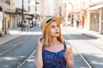 Portrait of beautiful young woman in hat