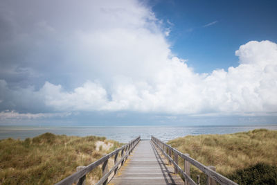 Scenic view of sea and pier against sky