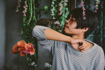 Close-up of young man with meerkat