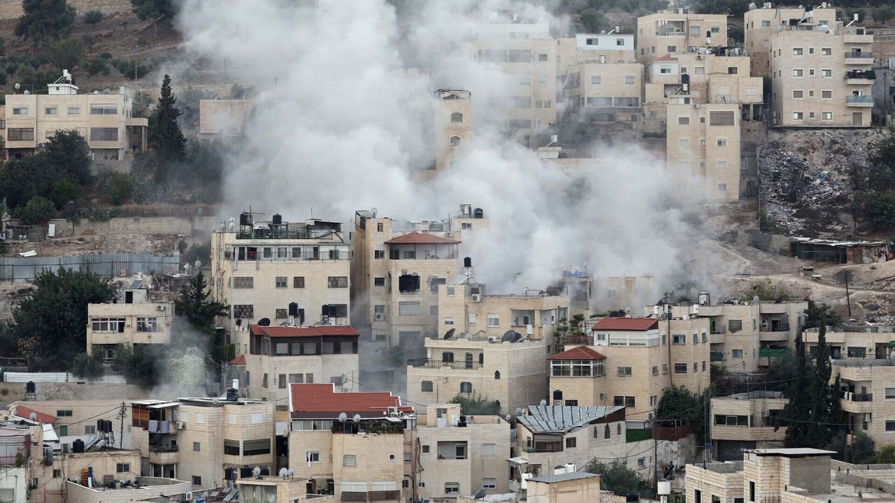 Houses in Gaza, Palestine with white smoke rising above them