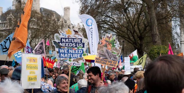 A group of campaigners with signs to protect nature