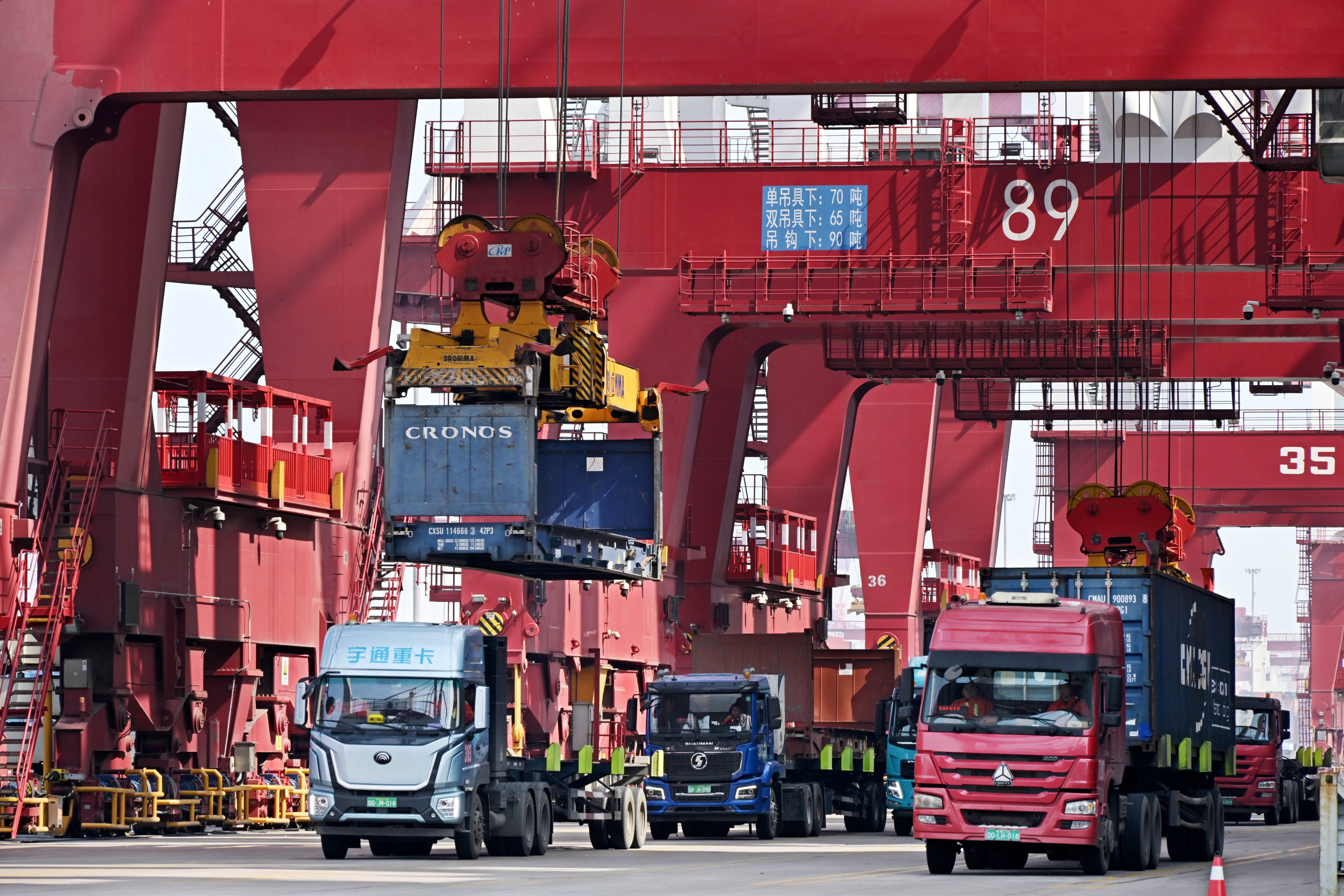 Trucks haul containers at the port of Qingdao in Shandong province in eastern China. Photo: Xinhua