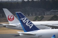 The tails of a Japan Airlines plane, rear, and an All Nippon Airways plane are seen at Narita International Airport in Narita, Chiba Prefecture, on March 17, 2024. (Mainichi/Tadakazu Nakamura)