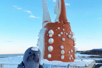 北海道紋別市のご当地ゆるキャラ「紋太」と観光名所になっている「カニの爪オブジェ」＝紋別観光振興公社提供