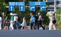 People walk near the Imperial Palace in Tokyo's Chiyoda Ward under strong sunlight in this June 12, 2024, file photo. (Mainichi/Tatsuro Tamaki)