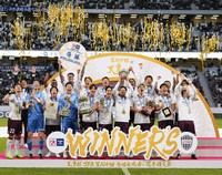 Vissel Kobe players celebrate as they lift the Emperor's Cup trophy at Tokyo's National Stadium on Nov. 23, 2024. (Kyodo)