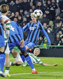 Celtic's Daizen Maeda, bottom, scores against Club Brugge during the second half of a Champions League league-phase match at Celtic Park in Glasgow, Scotland, on Nov. 27, 2024. (Kyodo)