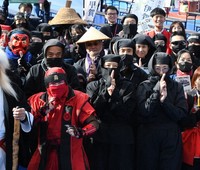 Participants who changed into ninja costumes at Ueno Park in Tokyo's Taito Ward pose for a photo before a tour of places associated with the Mie Prefecture city of Iga and the Shiga Prefecture city of Koka -- birthplaces of two major ninja schools -- on Nov. 23, 2024. (Mainichi/Yasuhiro Onishi)