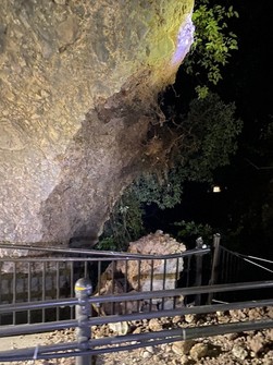 The sidewalk with a fence warped by a falling rock is seen in the "Ao-no-Domon" tunnel in Nakatsu, Oita Prefecture, in this photo provided by the city government.