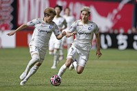 Machida Zelvia's Shota Fujio, right, and Yu Hirakawa go on the attack during a J-League first-division football match against Consadole Sapporo at Sapporo Dome on March 16, 2024. (Kyodo)