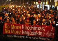 Residents holding torches walk the streets of Oslo, Norway, calling for peace, on Dec. 10, 2024. (Mainichi/Kenji Ikai)