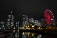 The large Ferris wheel lit up in red and skyscrapers of the Minatomirai district are seen in Yokohama's Naka Ward in this Jan. 6, 2021, file photo. (Mainichi/Kimitaka Takeichi)