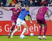 Holstein Kiel's Shuto Machino, center, vies for the ball against Augsburg during a German Bundesliga match at Holstein-Stadion, Kiel, on Dec. 21, 2024. (Kyodo)