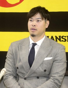 Hanshin Tigers third baseman Teruaki Sato attends a press conference after renewing his contract with the club in Nishinomiya, Hyogo Prefecture, on Dec. 23, 2024. (Kyodo)