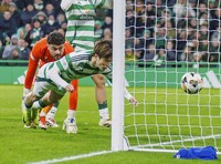 Japan's Kyogo Furuhashi, front, heads a goal for Celtic during a Scottish Premiership football match against St. Johnstone at Celtic Park in Glasgow, Scotland, on Dec. 29, 2024. (Kyodo)