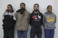 In this photo released by Syrian State TV, four suspects arrested in connection with an alleged plot by ISIS are shown standing against a wall in Damascus, Syria, on Jan. 11, 2025. (Syrian State TV via AP)