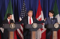 President Donald Trump, center, reaches out to Mexico's President Enrique Pena Nieto, left, and Canada's Prime Minister Justin Trudeau as they prepare to sign a new United States-Mexico-Canada Agreement that is replacing the NAFTA trade deal during a ceremony at a hotel before the start of the G20 summit in Buenos Aires, Argentina, on Nov. 30, 2018. (AP Photo/Martin Mejia, File)