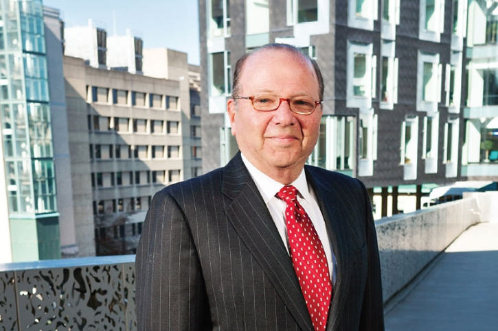 Jared Cohen standing in front of buildings 