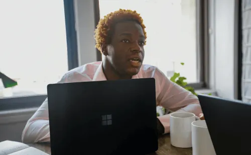 A young man working on a laptop