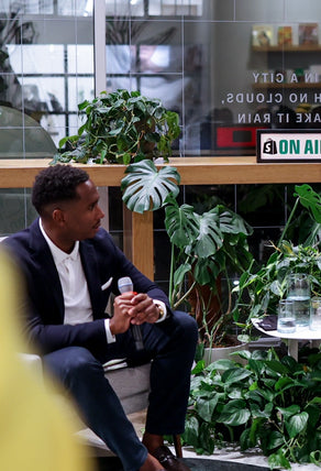 A close-up photo of a successful Black entrepreneur and guest of a Build Black Community event giving members exclusive business insights.